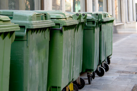 A group of garbage bins containers along a city street, disposal, waste recycling, waste separation, maintenance, hygiene, sanitationの写真素材