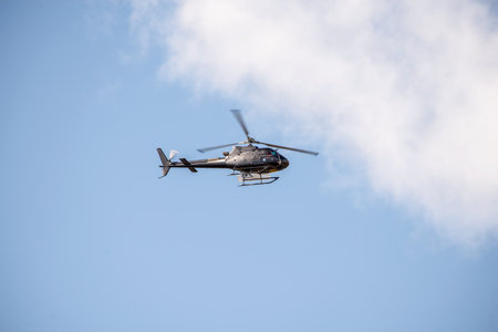 A disaster relief helicopter flies in the sky. Rescue services. Aerial surveillance.の写真素材