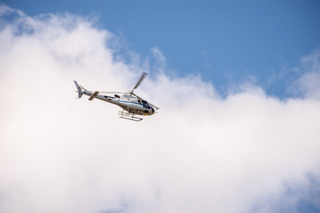 A disaster relief helicopter flies in the sky. Rescue services. Aerial surveillance.の写真素材