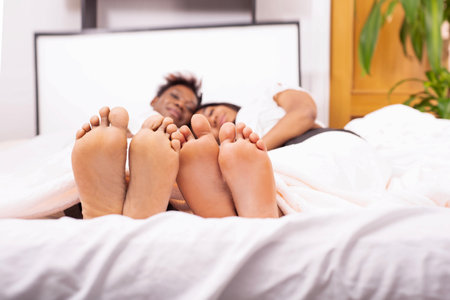 two women's feet close up, selective focus. concept Relaxing together at home., foot health or problems. Spending time in company. Doing nothing, waking upの写真素材