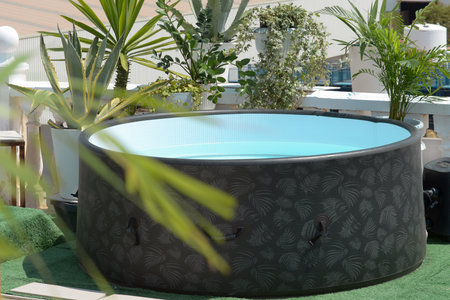 A round inflatable swimming pool on an outdoor terrace or rooftop of a houseの写真素材