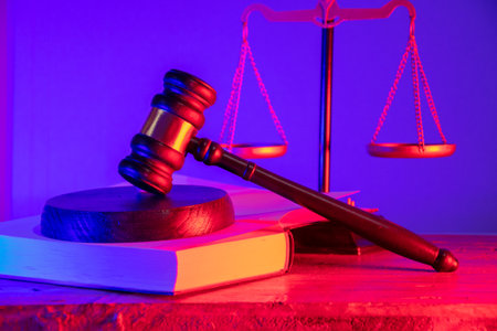 Wooden gavel on a statute book with scales of justice. The inviolability of the judicial system. Legal decisions and the concept of fairness in courtの写真素材