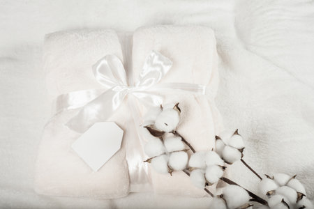 soft surface of a fluffy plaid with a mockup sign for an inscription, with a gift ribbon. fluffy plaid in color of the year 2026の写真素材