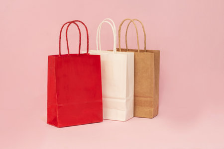 A festive presentation of gift purchases in paper bags on a social media displayの写真素材