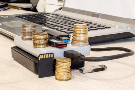 Stacks of coins, USB drives, flash drives, external hard drives, memory cards