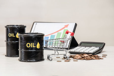 Oil barrels with a shopping cart and a price growth chart on a tablet represent fuel inflation and...