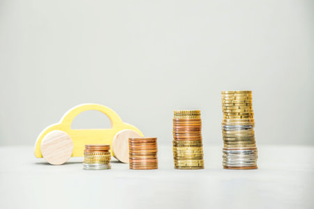 Car model and growing stacks of coins. Vehicle financing, car loan, car value, insurance, buying and selling. Concept of the global consumer auto economy. Maintenance costsの写真素材
