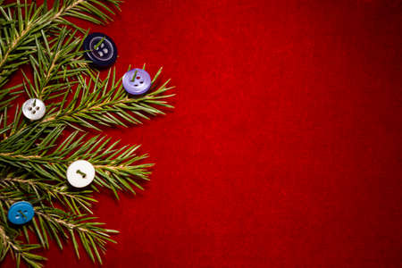 Christmas tree and buttons on red velvet