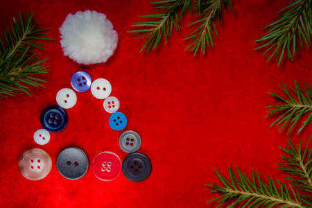 Christmas tree and buttons on red velvet