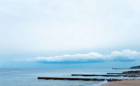 landscape, the blue sky with low clouds merges with the blue sea with breakwaters. can be used as background. concept of serenity, calmの写真素材