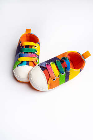 Multi-colored denim sports shoes for baby, stands on a white background. The concept of childrens clothing.の写真素材