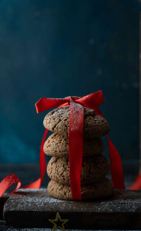 christmas card, dark background, toys and homemade cookies in a tin can