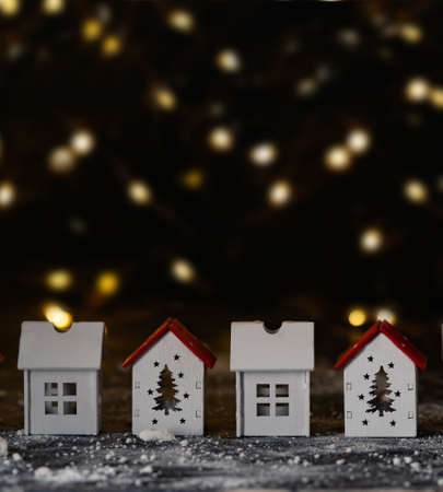 small white houses on a dark background with bokeh, christmas card