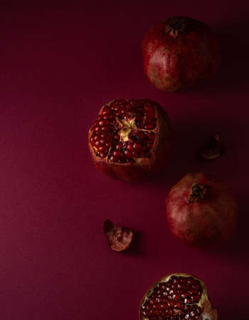 maroon grenades lie on a maroon background, top viewの写真素材