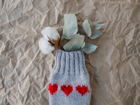 composition with florals in knitted sock with red hearts ornamentの写真素材
