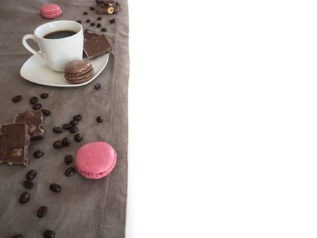 Coffee cup, beans, chocolate and macaroons on old kitchen table with copyspace for your textの写真素材