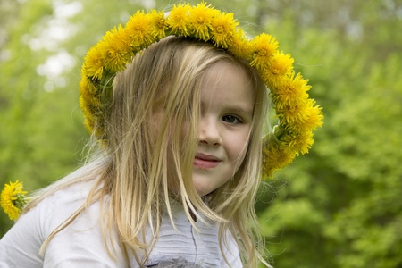 beautiful girl with flowers on her head smilingの写真素材