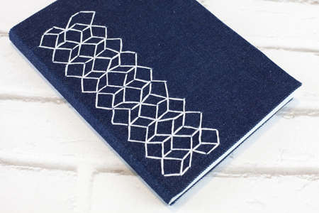 Handmade notebook with hexagonal embroidery fabric coverの写真素材
