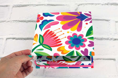 Colorful elegant gift packaging box. Open with hand.の写真素材