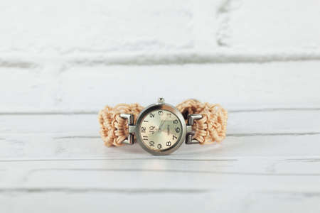 Silver watch with beige macrame strapの写真素材