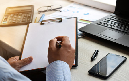 Finance and business concept. Business man working with laptop and documents. Mobile technologies, internet, vintage color, selective focus.の写真素材