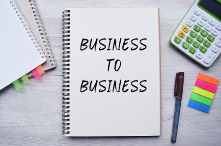 Text written on a Notepad on a business or financial topic. Top view of the calculator, documents, and desktop. Business conceptの写真素材