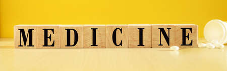 The inscription medical subjects on wooden cubes, a bright yellow background. Health and medicine...