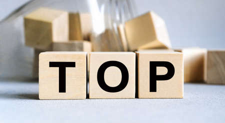 The inscription TOP on wooden cubes isolated on a light background, the concept of business and finance.の写真素材