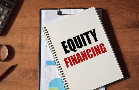 The inscription on a notebook on a medical theme. Doctor's workplace. Top view on a red background with medical equipment - stethoscope, medical masks, glasses.の写真素材