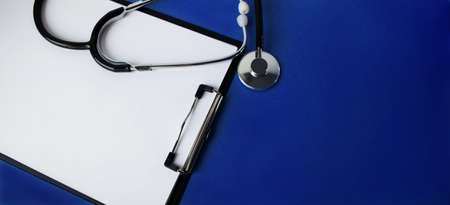 Wooden figurine of a man, holding two pills, on a light background with free space for your text. Medicine and healthcare concept.の写真素材