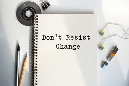 Notepad with concept lettering. Paper cup with coffee and paper bag with breakfast on the table. View from above. Marketing concept.の写真素材