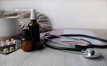 A notebook with the inscription IT IS ALL IN YOUR HANDS on a light table along with a pink flower and earphones for the phone. Natural light. Marketing concept. Top view, flat lay. Spring theme.の写真素材