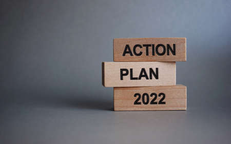 A poster with the words STOP RACIST VIOLENCE in the hands of a young girl against a blue sky.の写真素材