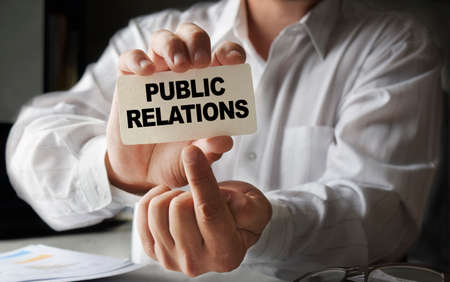 Willow branch against the background of the river and trees on a spring sunny day. natural image. The concept of the awakening of nature.の写真素材