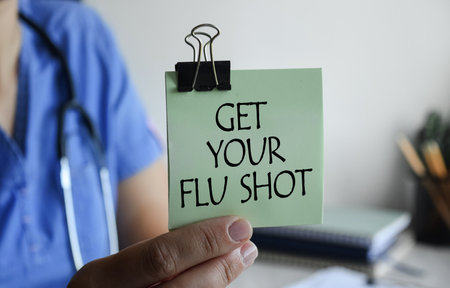 A doctor in blue medical gloves holds a clipboard with the inscription FOOD SAFETY, a stethoscope, a...