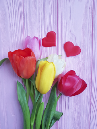 Tulips on wooden red heartの写真素材