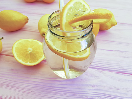 water with lemon orange on a woodenの写真素材