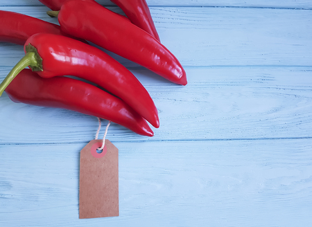 red pepper on a wooden tagの写真素材