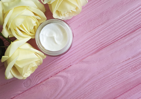 cosmetic cream, yellow rose on a pink woodenの写真素材