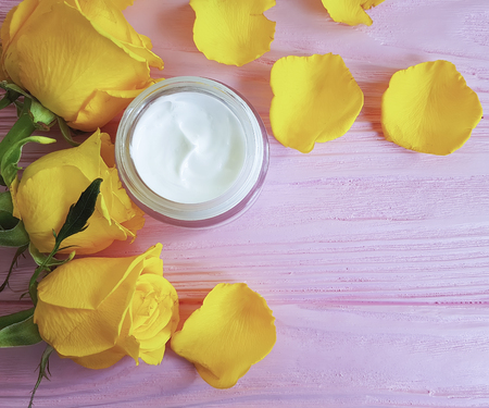 cosmetic cream, yellow rose on a pink woodenの写真素材