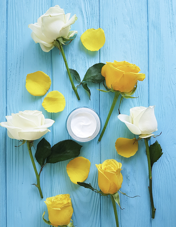 cosmetic cream, yellow rose on blue woodの写真素材