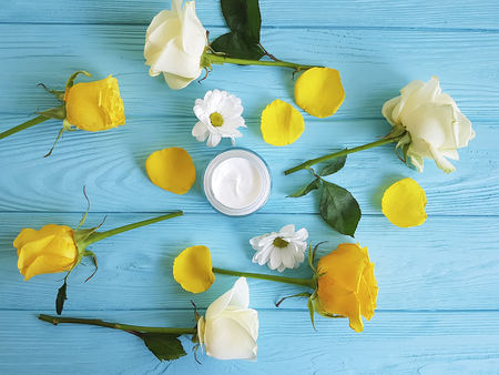 cosmetic cream, yellow rose on blue woodの写真素材