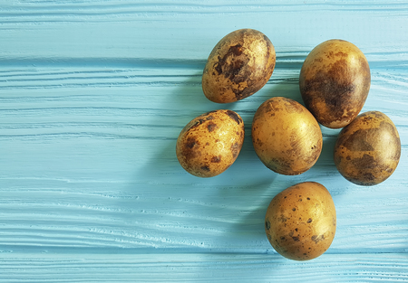 Easter quail eggs on blue woodenの写真素材