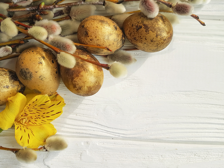quail eggs easter branch of a willow on a white wooden background, flower alstroemeriaの写真素材