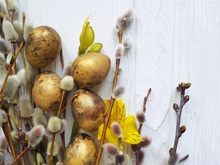 quail eggs easter branch of a willow on a white wooden background, flower alstroemeriaの写真素材