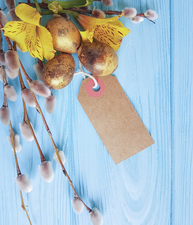 quail eggs easter branch of a willow on a white wooden background, flower alstroemeriaの写真素材