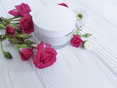 cream cosmetic natural pink rose rose white flowers white woodenの写真素材