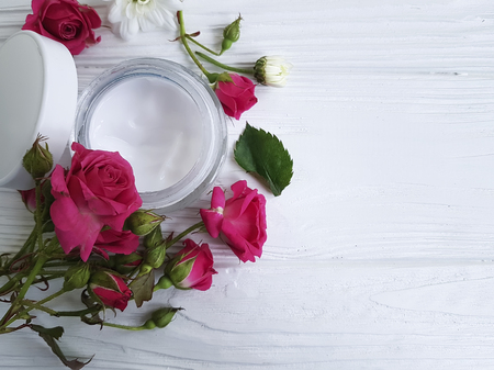 cream cosmetic natural pink rose rose white flowers white woodenの写真素材