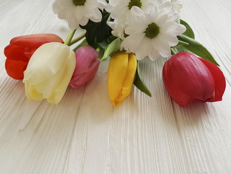 beautiful bouquet of tulips on white woodenの写真素材