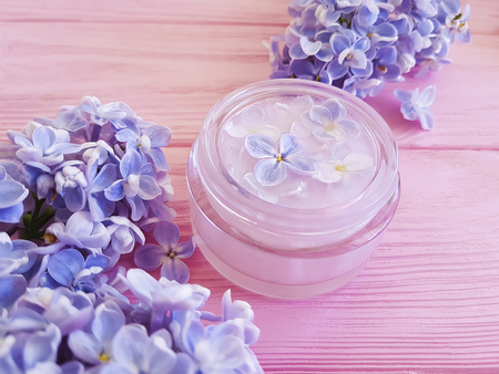 cream cosmetic lilac on pink woodenの写真素材